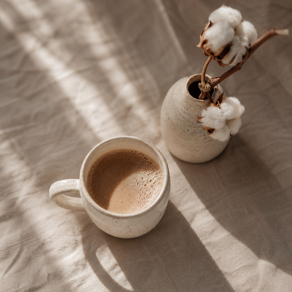 Morning coffee on a linen-covered bed